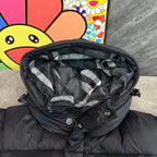Dark puffer jacket with button placket and checkered hood lining