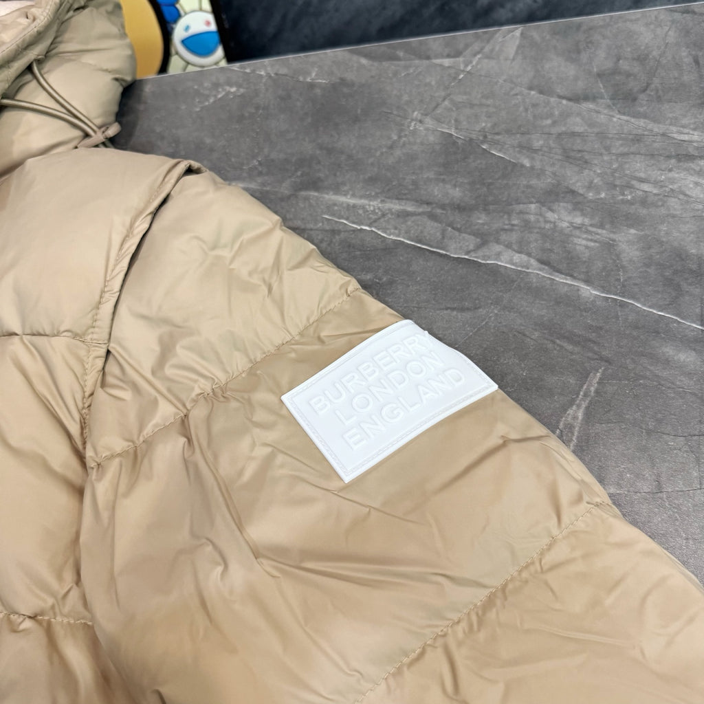 Burberry puffer jacket, light beige with stitched quilting and brand label tag.