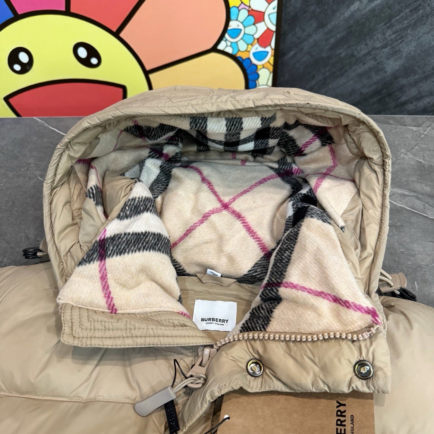 Burberry puffer jacket hood lining, beige with plaid interior and quilted trim.