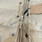 Burberry puffer jacket front, light beige with zip pull, snap buttons, and hardware.