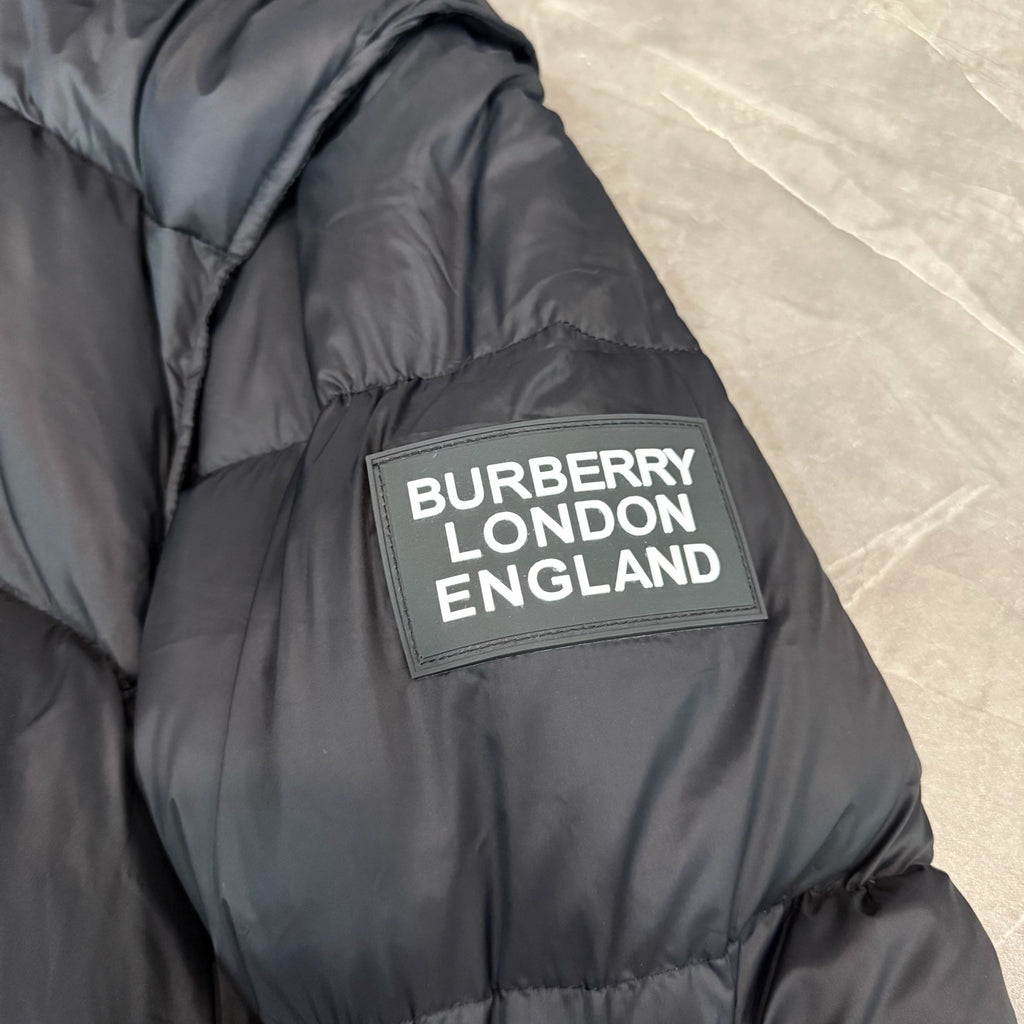 Dark puffer coat with 'BURBERRY LONDON ENGLAND' logo patch