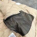Burberry puffer jacket, light beige with black mesh inner pocket opening.