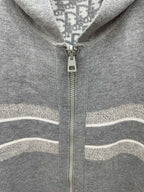 Heather gray zip hoodie detail with centered zipper and striped knit trim