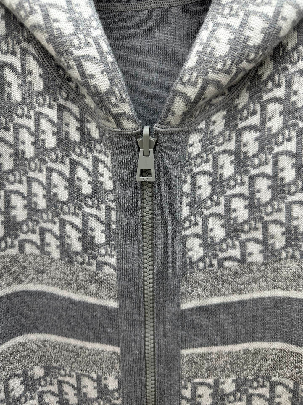 Heather gray zip hoodie detail: metal zipper pull on printed knit