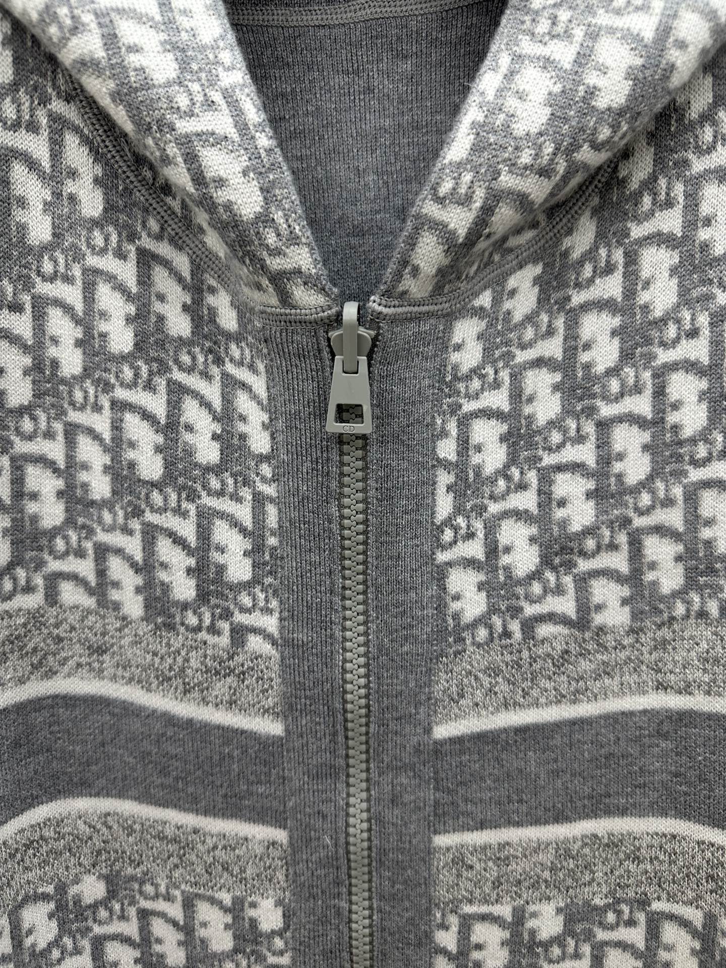 Heather gray zip hoodie detail: metal zipper pull on printed knit