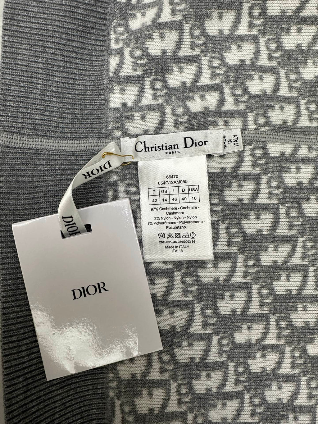 Brand tags attached to patterned zip hoodie fabric