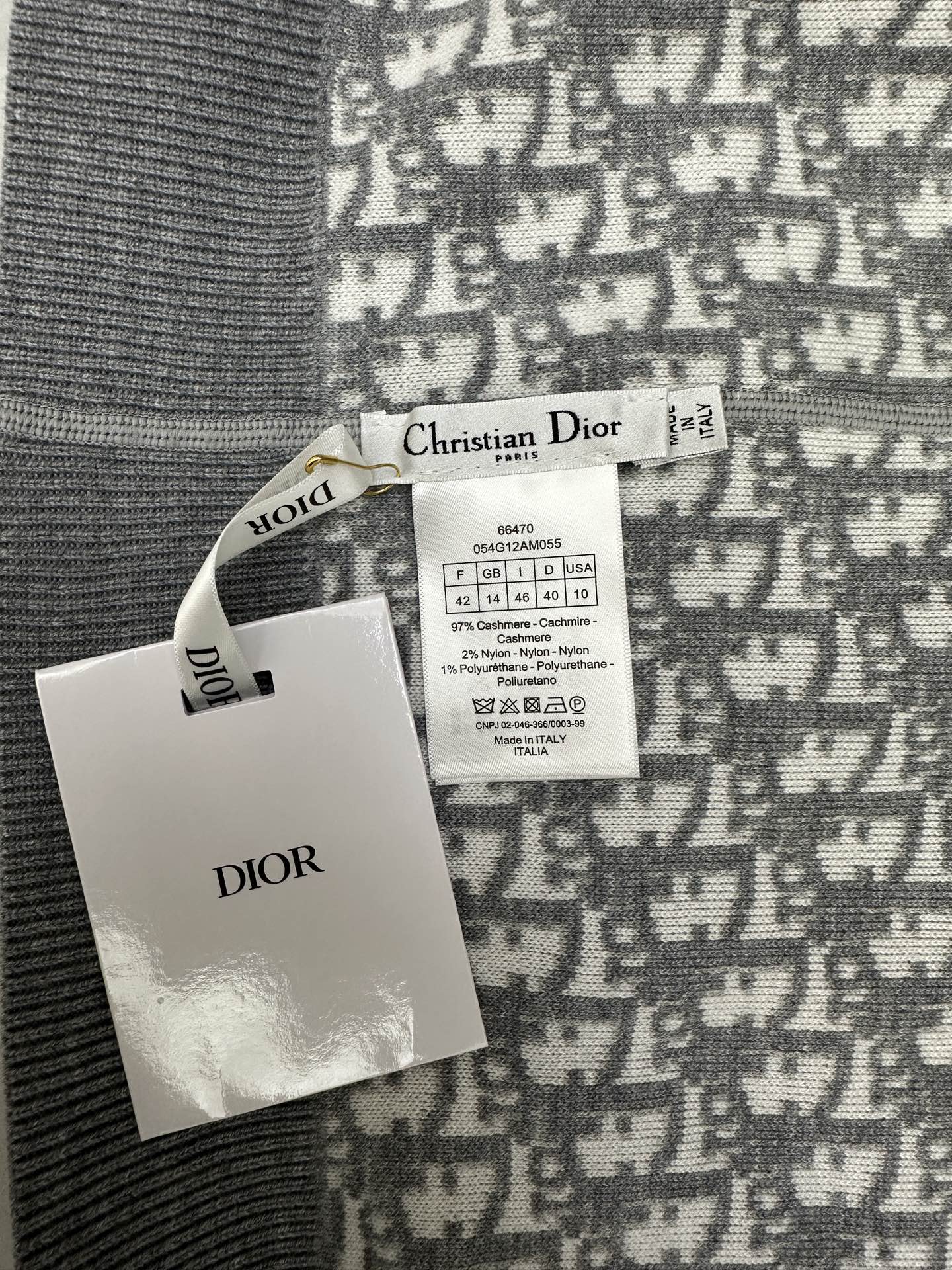 Brand tags attached to patterned zip hoodie fabric