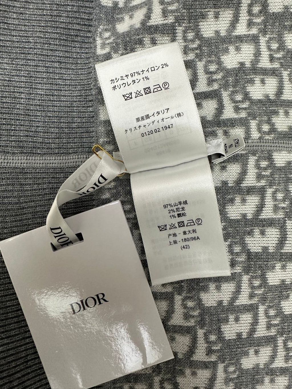 Care and size label on patterned zip hoodie with Dior logo tag