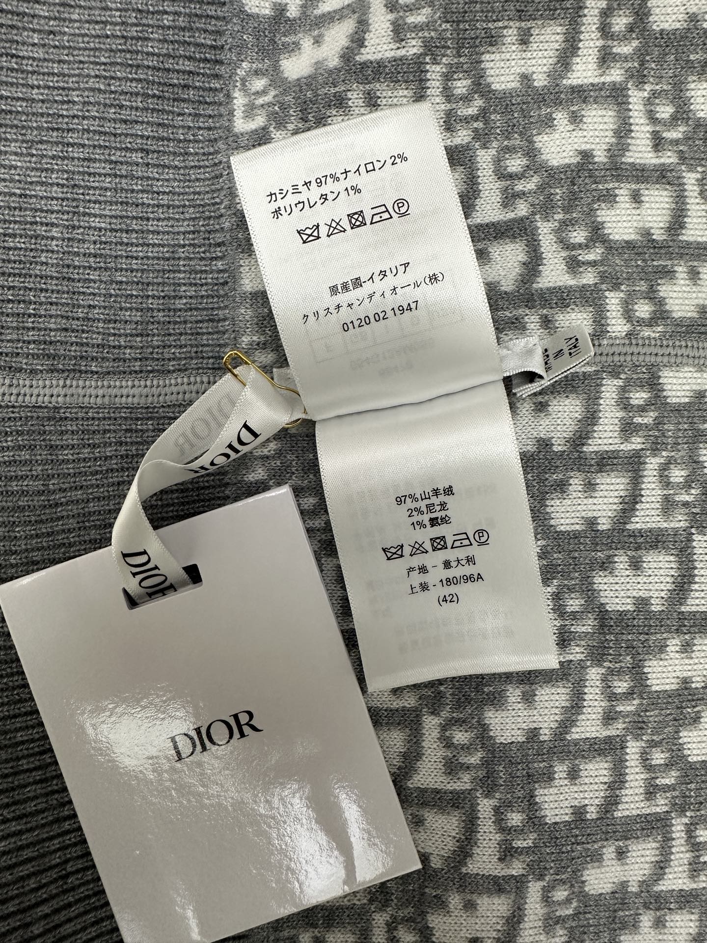 Care and size label on patterned zip hoodie with Dior logo tag