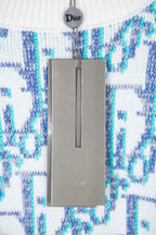 Dior knit sweater sleeve with blue logo pattern and gray product tag