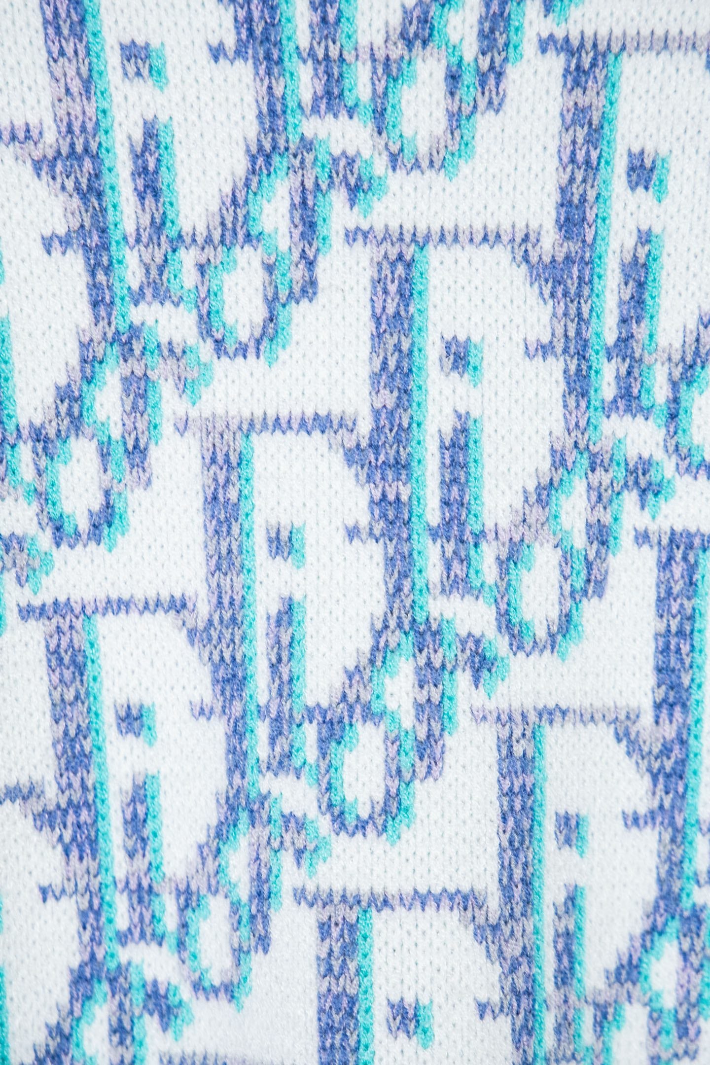 Dior knit sweater knit texture with blue abstract logo pattern on white