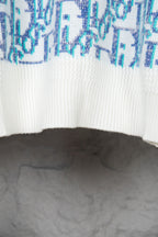 Dior knit sweater front hem with white ribbed knit and blue logo pattern