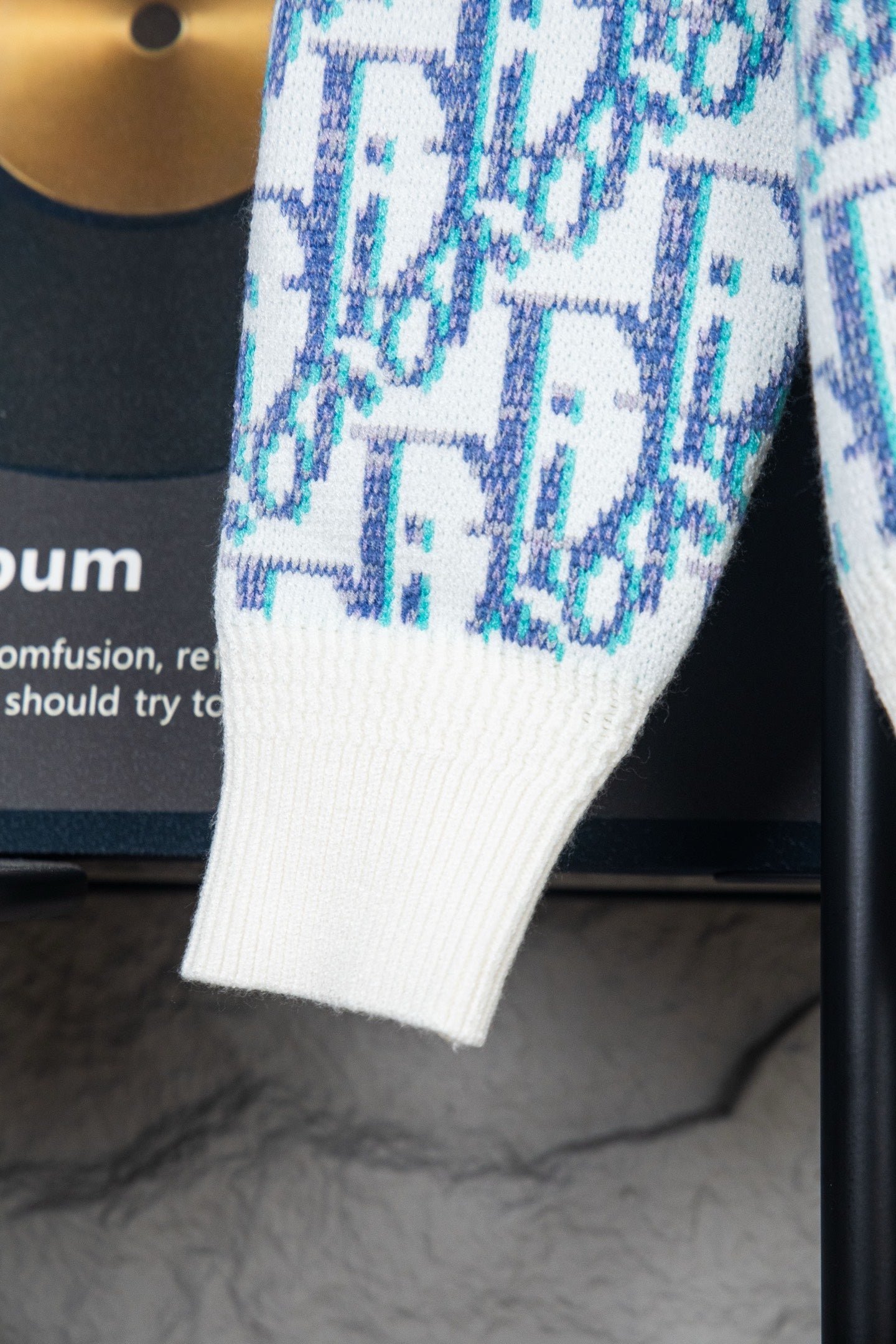 Dior knit sweater cuff and hem with white ribbing and blue logo pattern