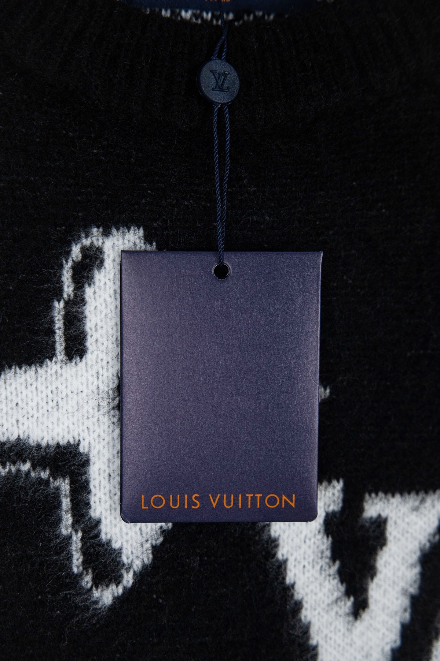 Louis Vuitton sweater neckline detail with hang tag on black knit