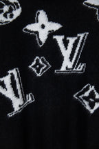 Louis Vuitton sweater close-up, black knit with white star and LV-style graphics