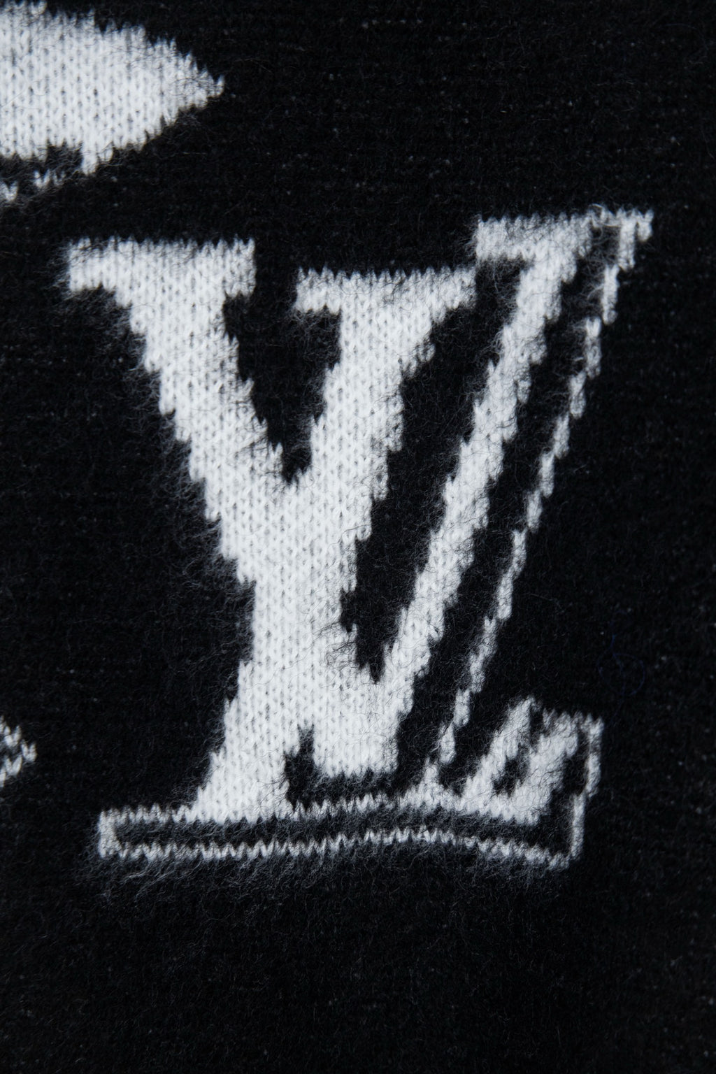 Louis Vuitton sweater close-up, large white LV monogram graphic on black knit