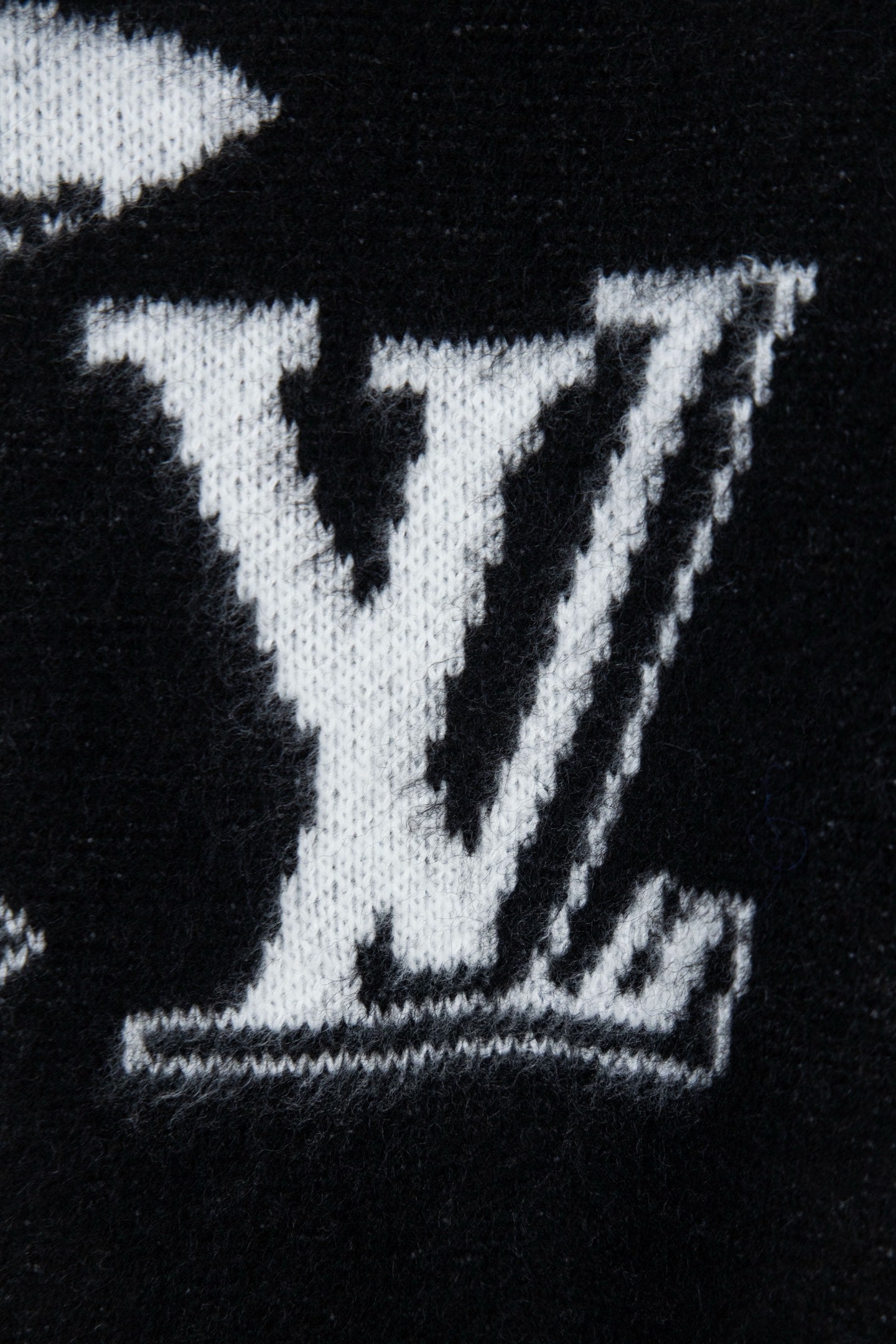 Louis Vuitton sweater close-up, large white LV monogram graphic on black knit