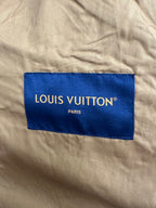Louis Vuitton fabric brand label on beige jacket lining with blue panel