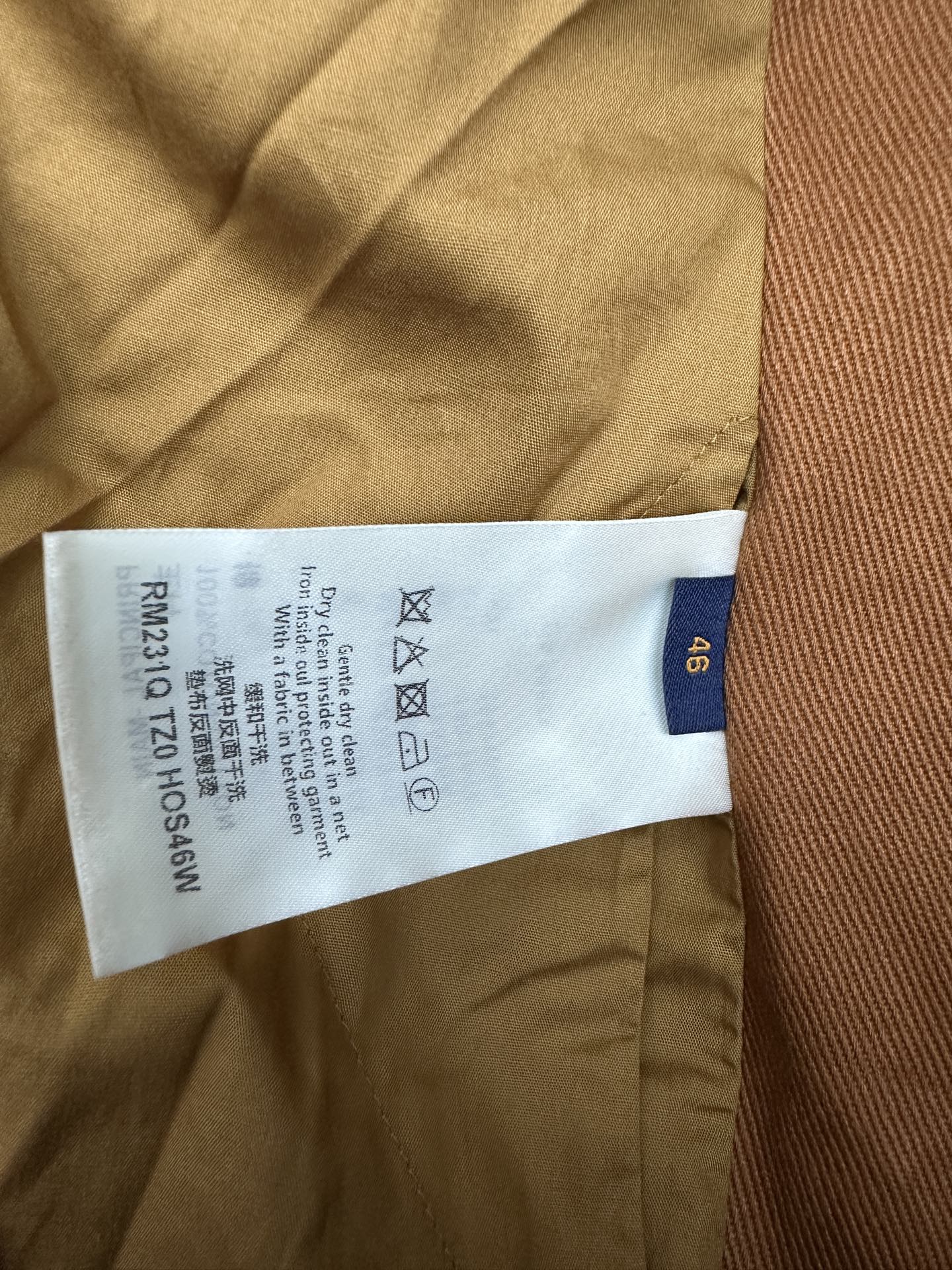 Louis Vuitton care label and size tag stitched inside brown jacket lining