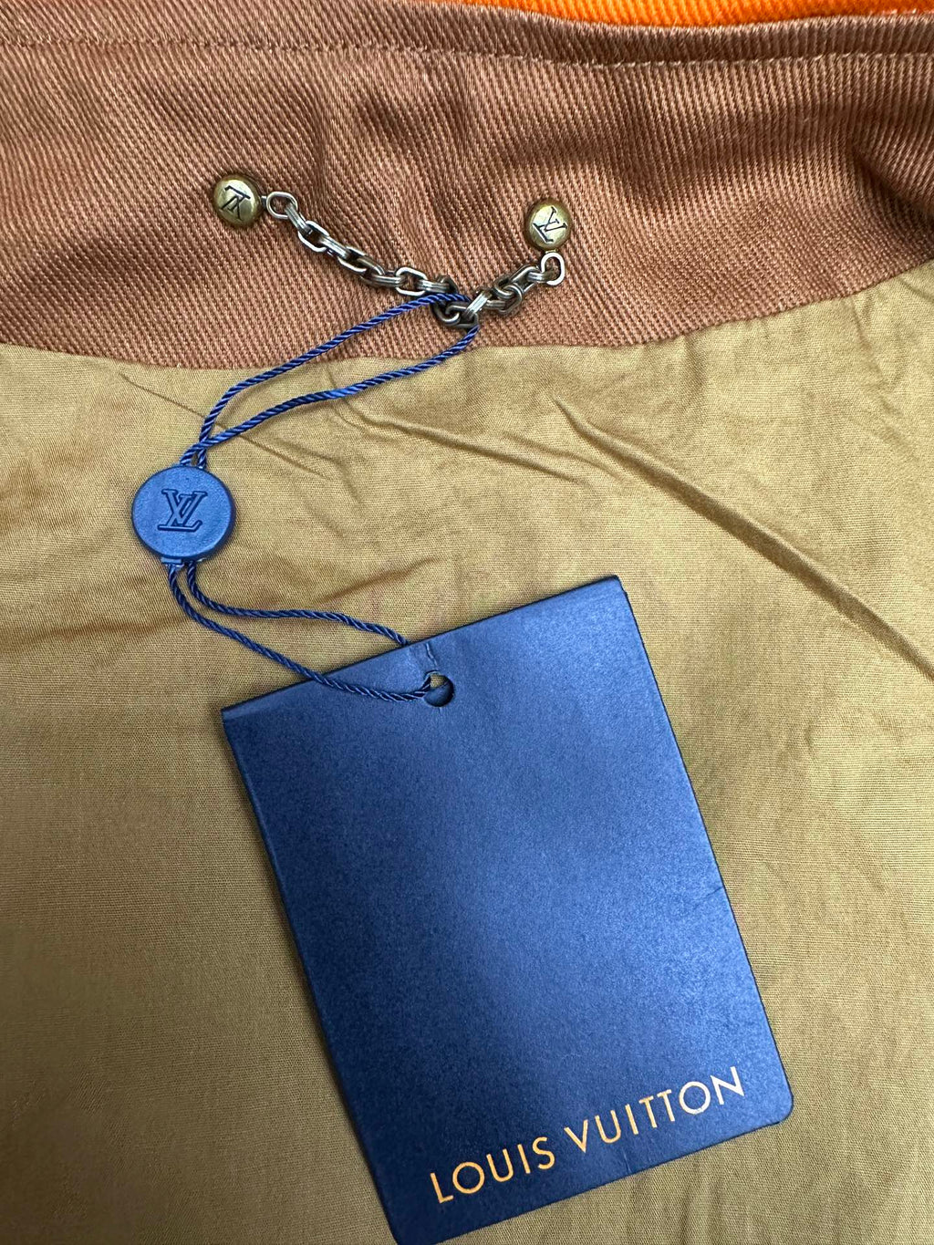 Louis Vuitton hood drawstring with chain and blue Louis Vuitton hang tag