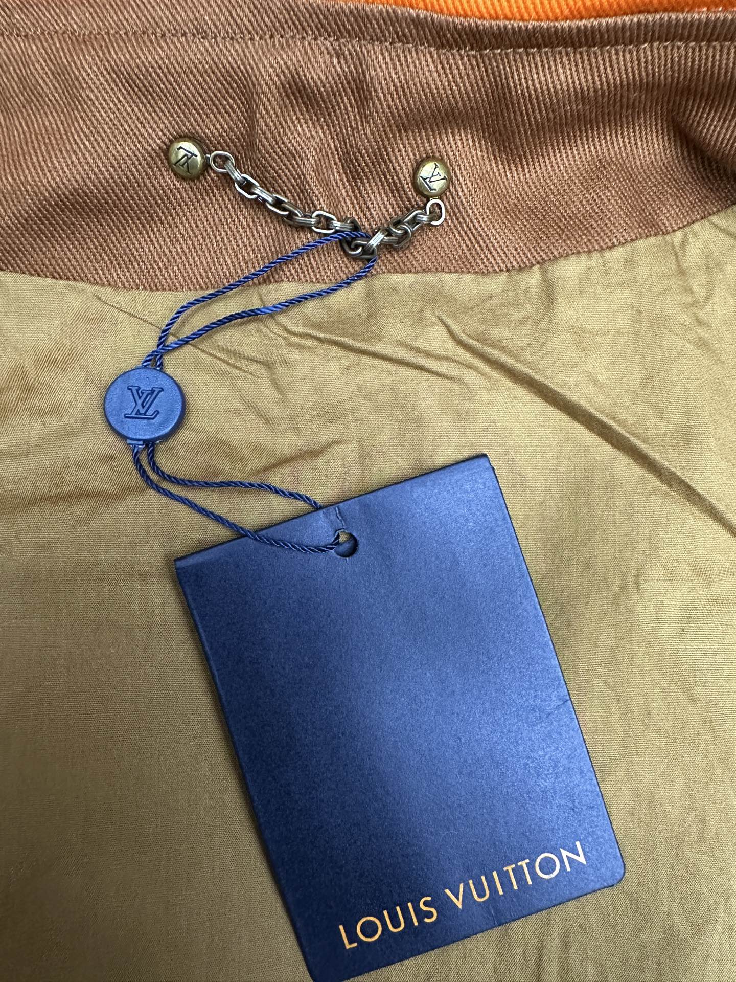 Louis Vuitton hood drawstring with chain and blue Louis Vuitton hang tag