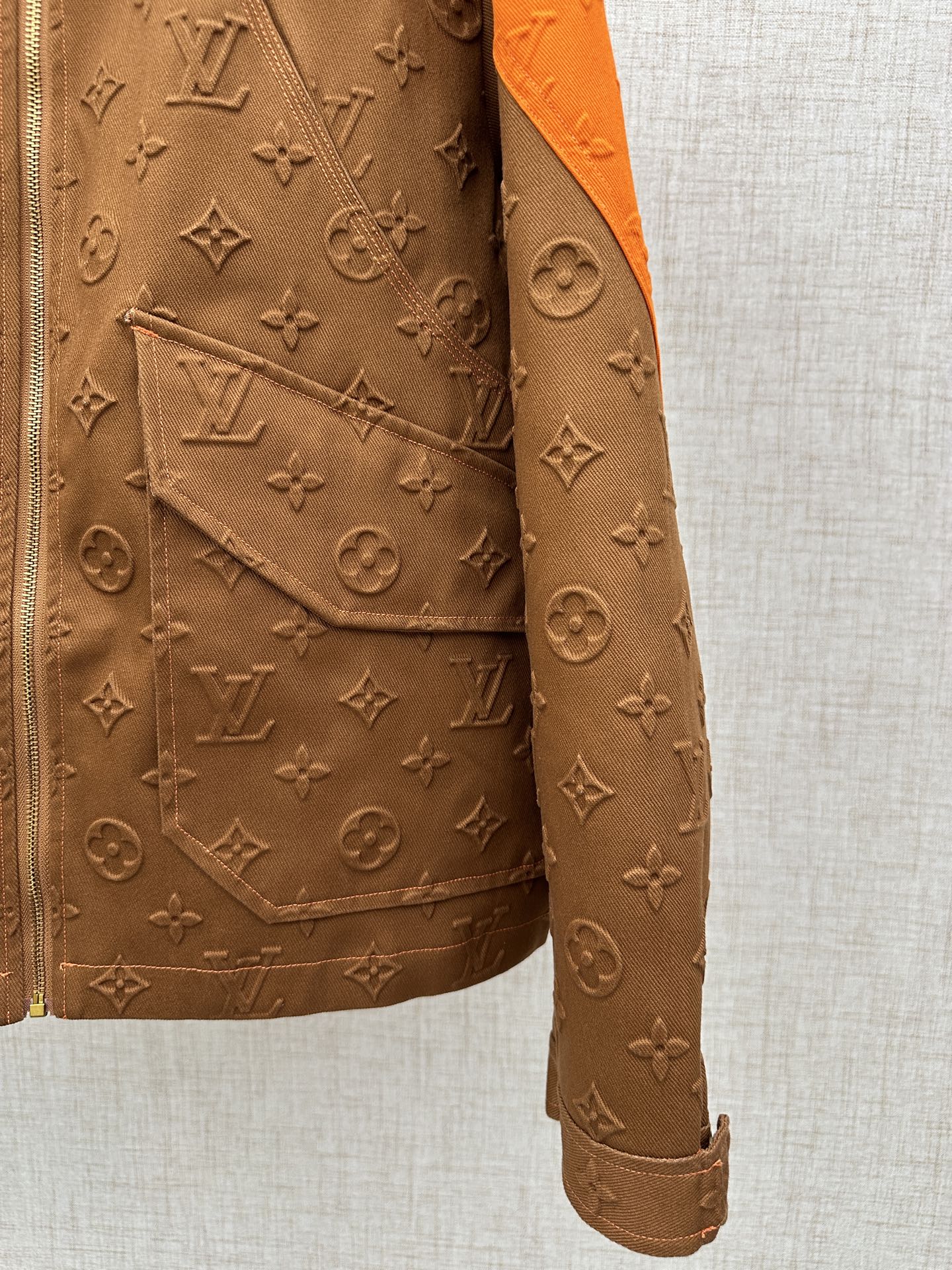 Louis Vuitton brown monogram jacket with diagonal pocket flap and orange hood lining