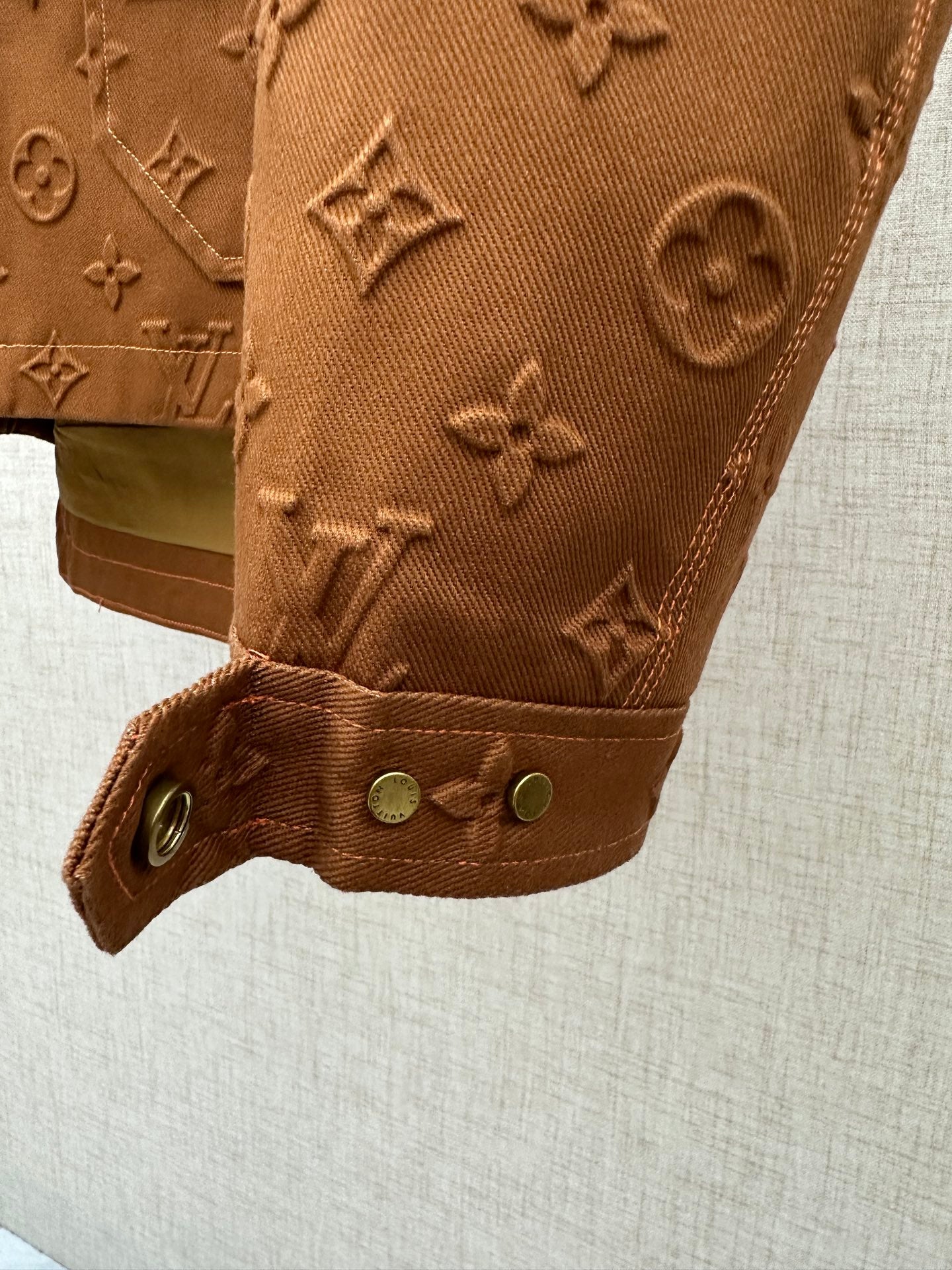 Louis Vuitton brown monogram jacket cuff with snap buttons and stitched strap