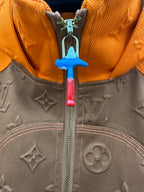 Louis Vuitton front zipper detail on brown monogram jacket with orange inner hood