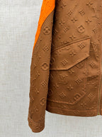 Louis Vuitton brown monogram jacket pocket flap with orange-trimmed collar
