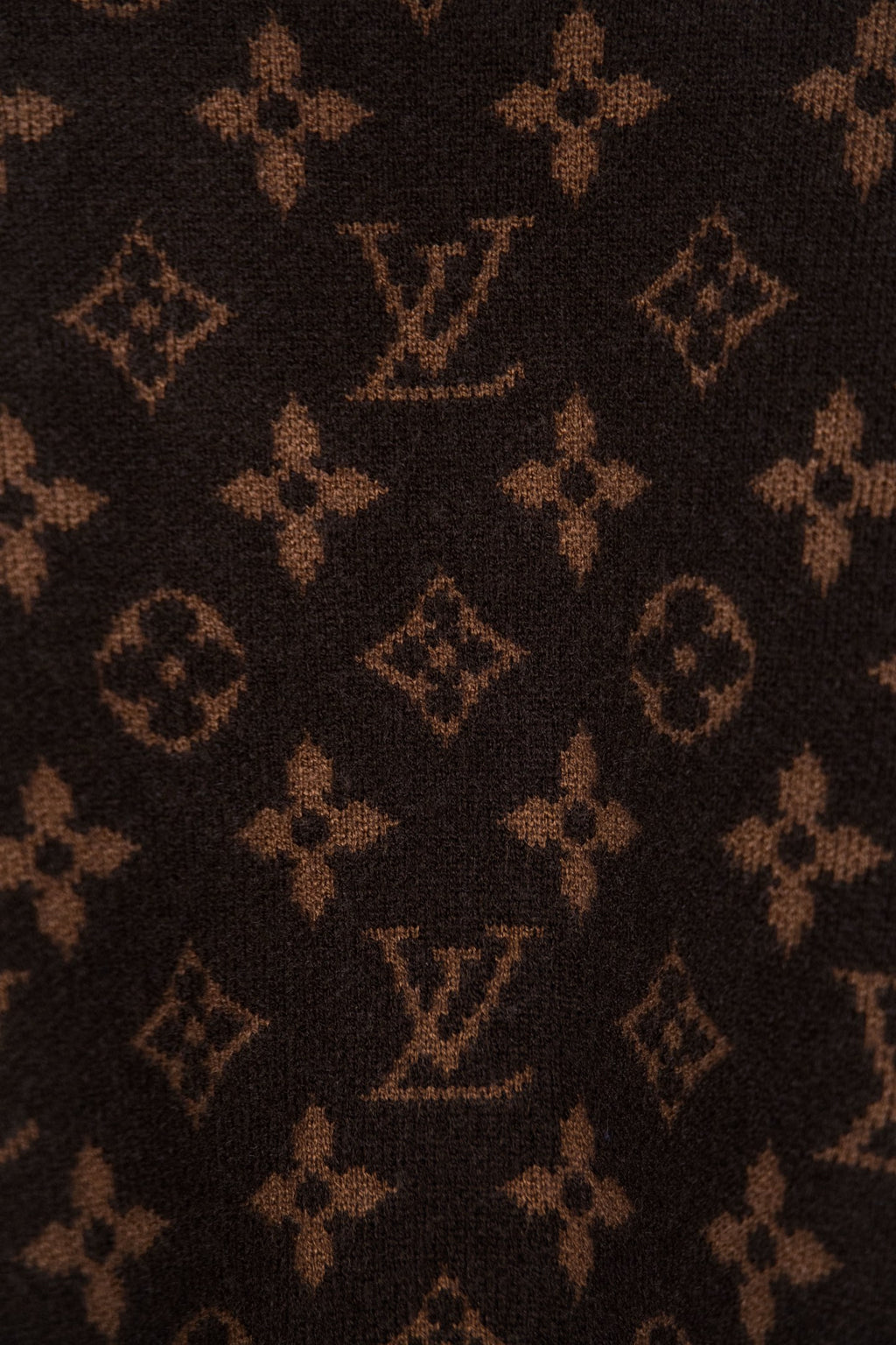 Dark brown monogram knit fabric with repeated logo pattern