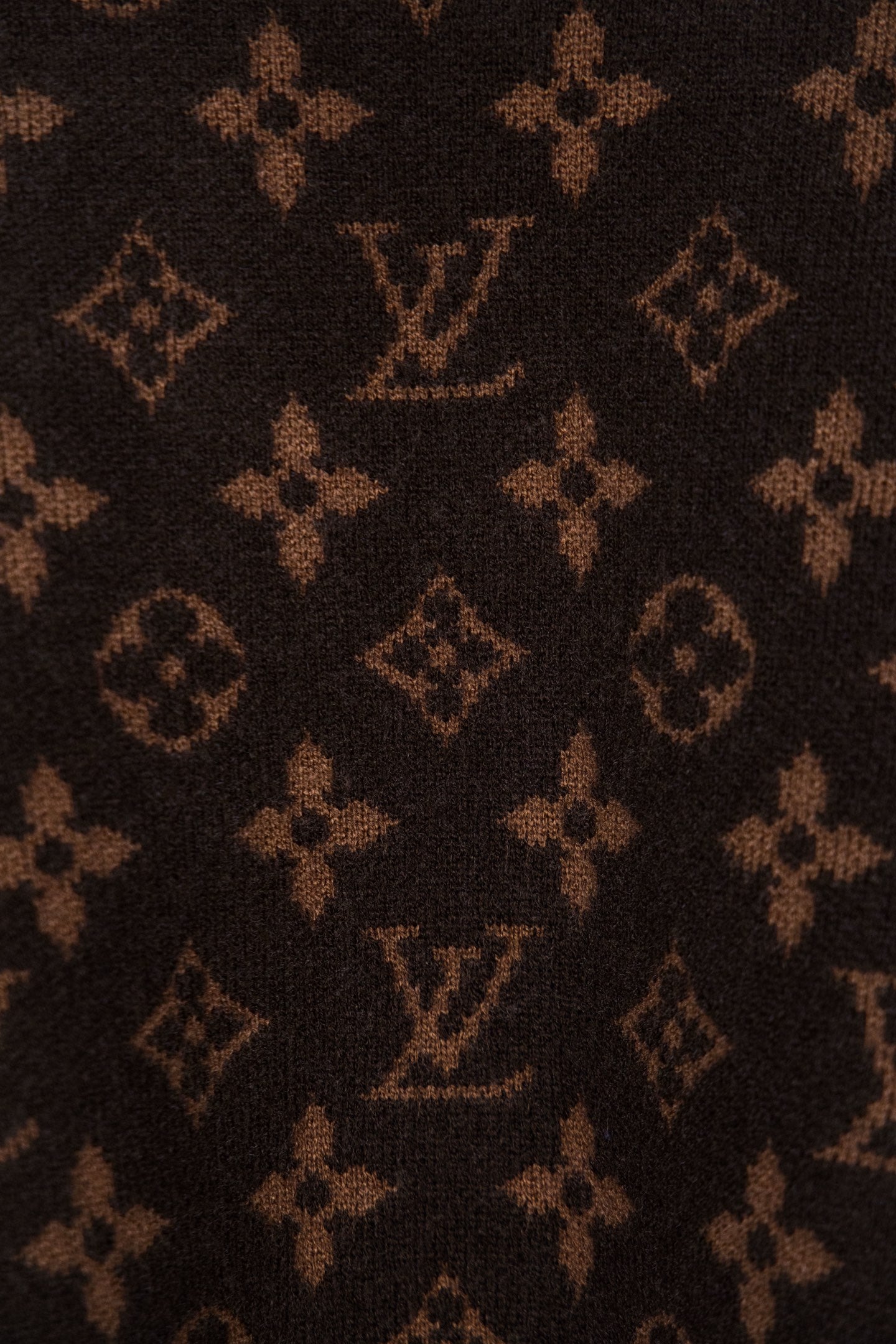 Dark brown monogram knit fabric with repeated logo pattern