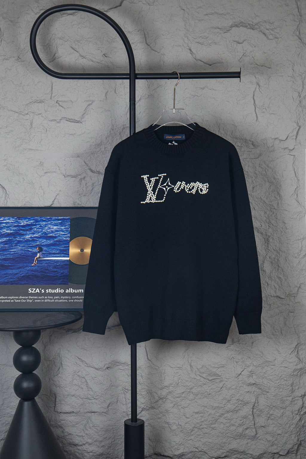 Dark long-sleeve knit sweater with rhinestone LV-style logo on chest