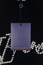 Black knit sweater with hanging Louis Vuitton tag and pearl logo details