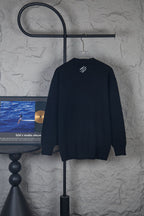 Dark long-sleeve knit sweater with small center logo on back