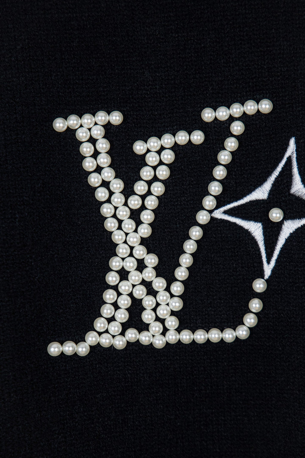Black knit sweater with large pearl-embellished lettering and star motif