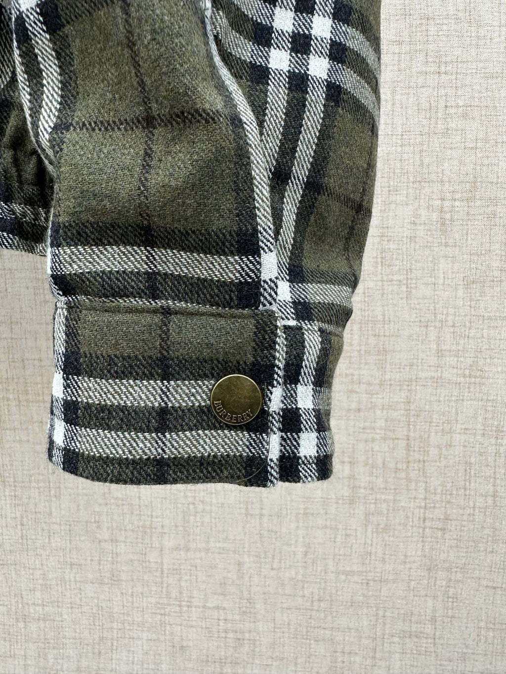 Long plaid coat sleeve cuff with round button