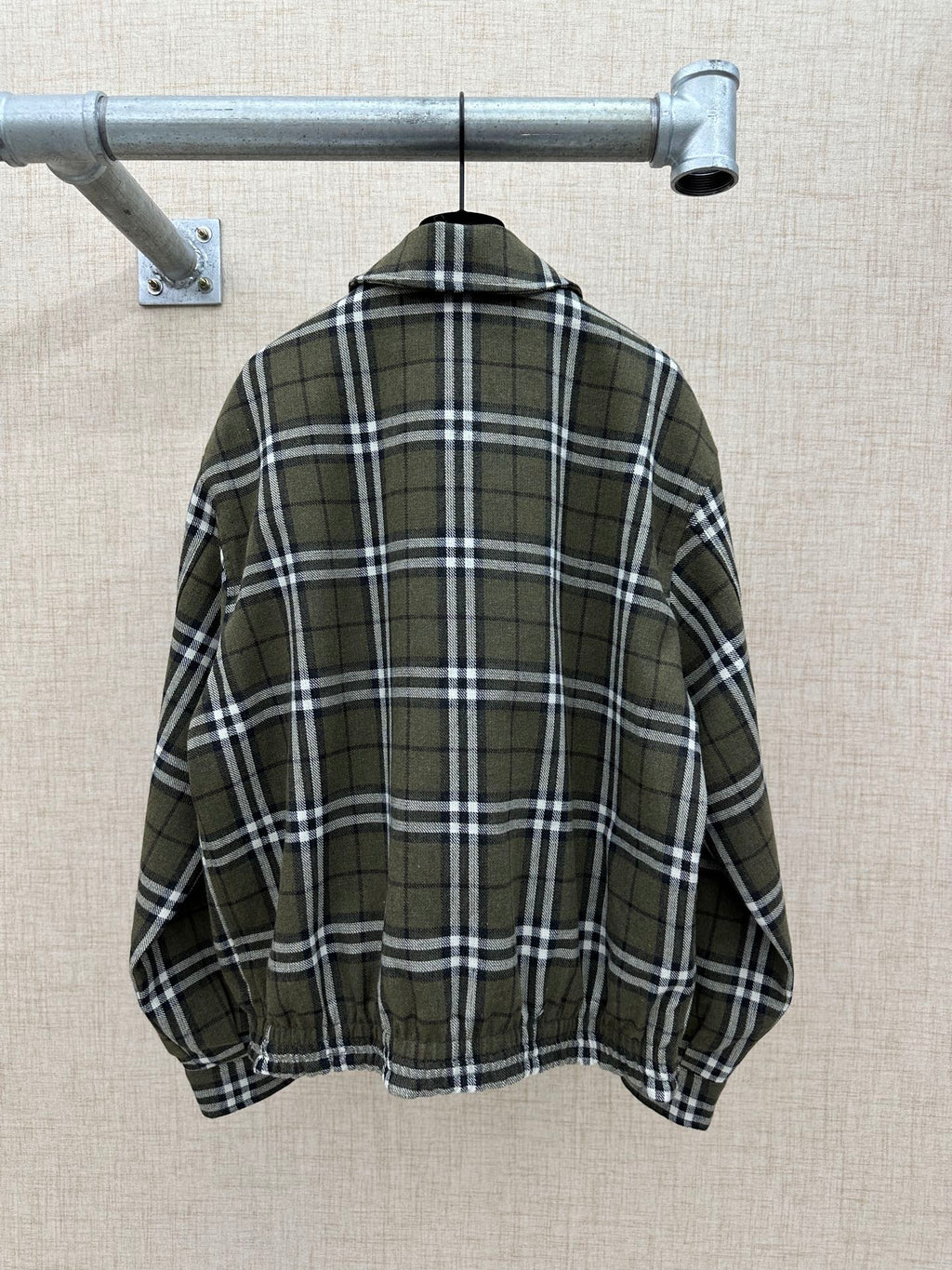 Olive green plaid jacket back view with stand collar and elastic hem