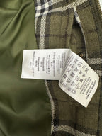Olive green plaid jacket with white care label on inner side