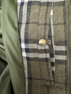 Olive green plaid jacket chest pocket with brass snap button detail