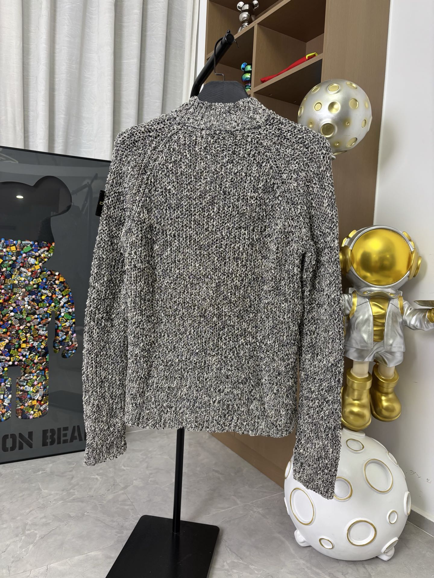 Textured zip jacket, black-and-white speckled knit, back view on hanger