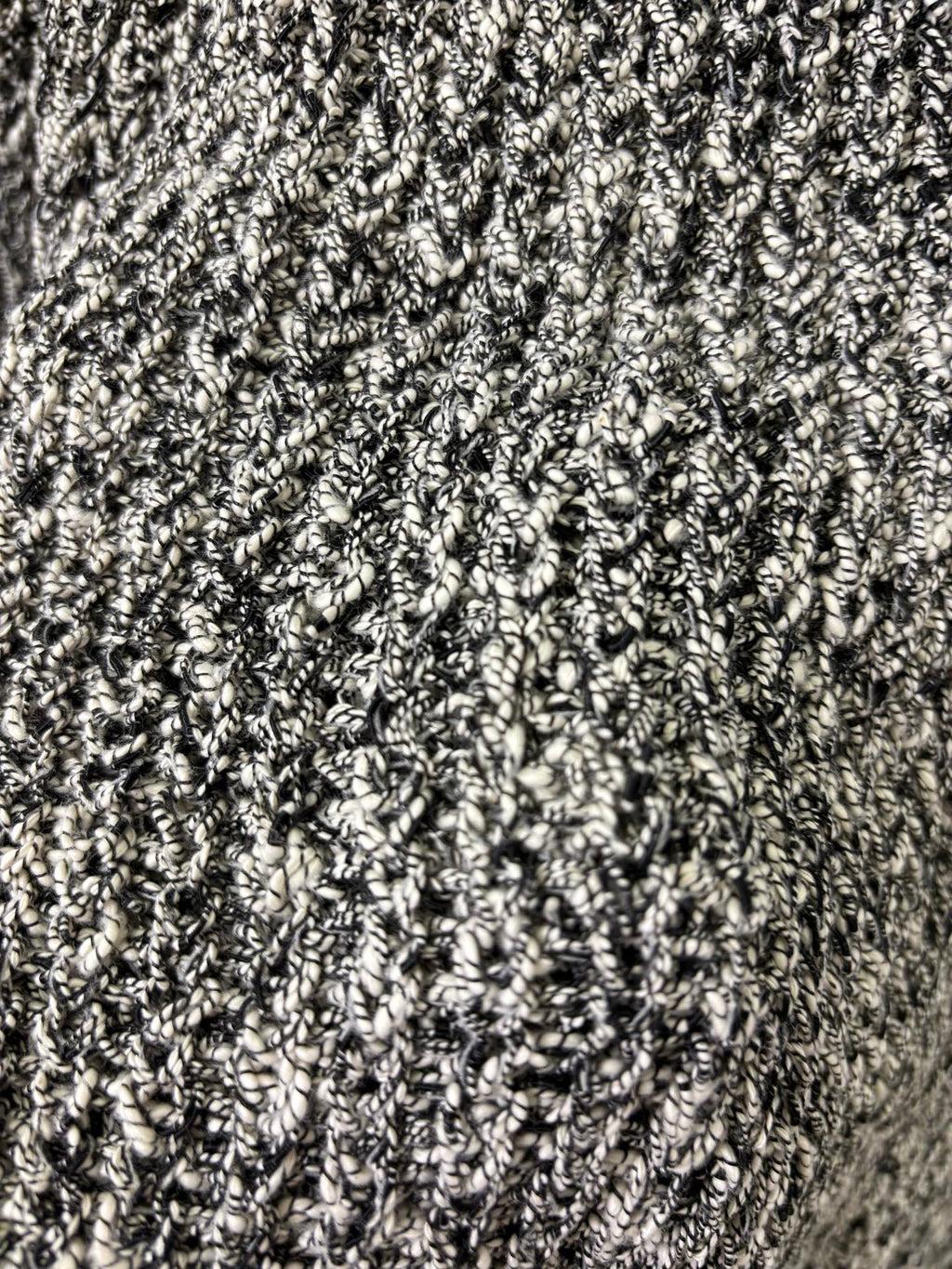 Black-and-white speckled textured knit fabric close-up