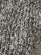 Black-and-white speckled textured knit fabric close-up