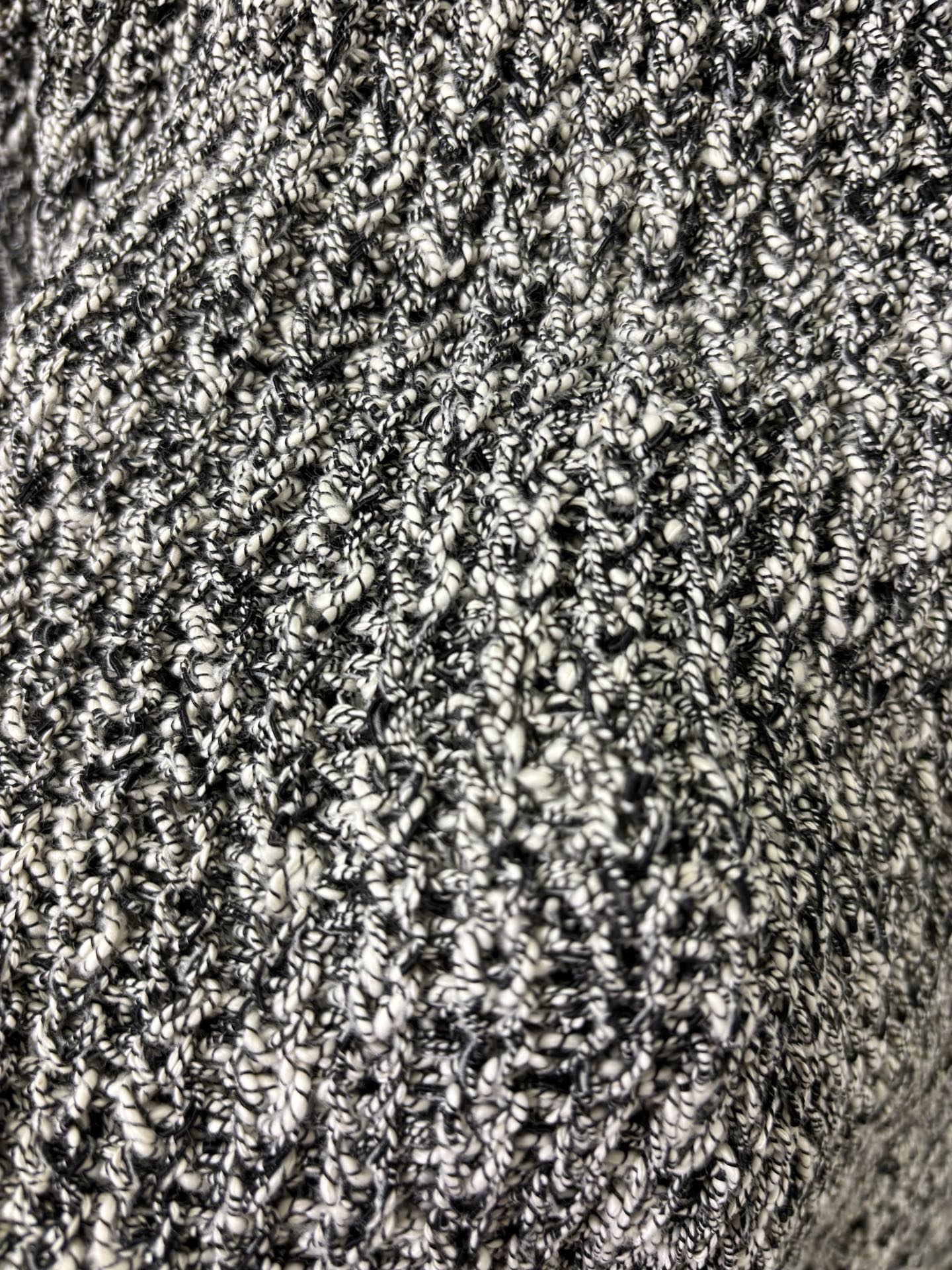 Black-and-white speckled textured knit fabric close-up