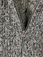 Close-up of front zipper on black-and-white speckled textured jacket