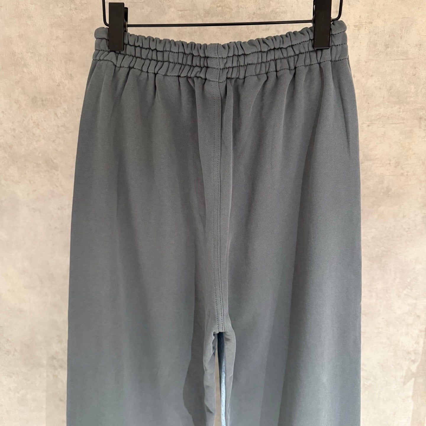 Balenciaga slate gray wide-leg pants close-up of elastic waistband and front slit