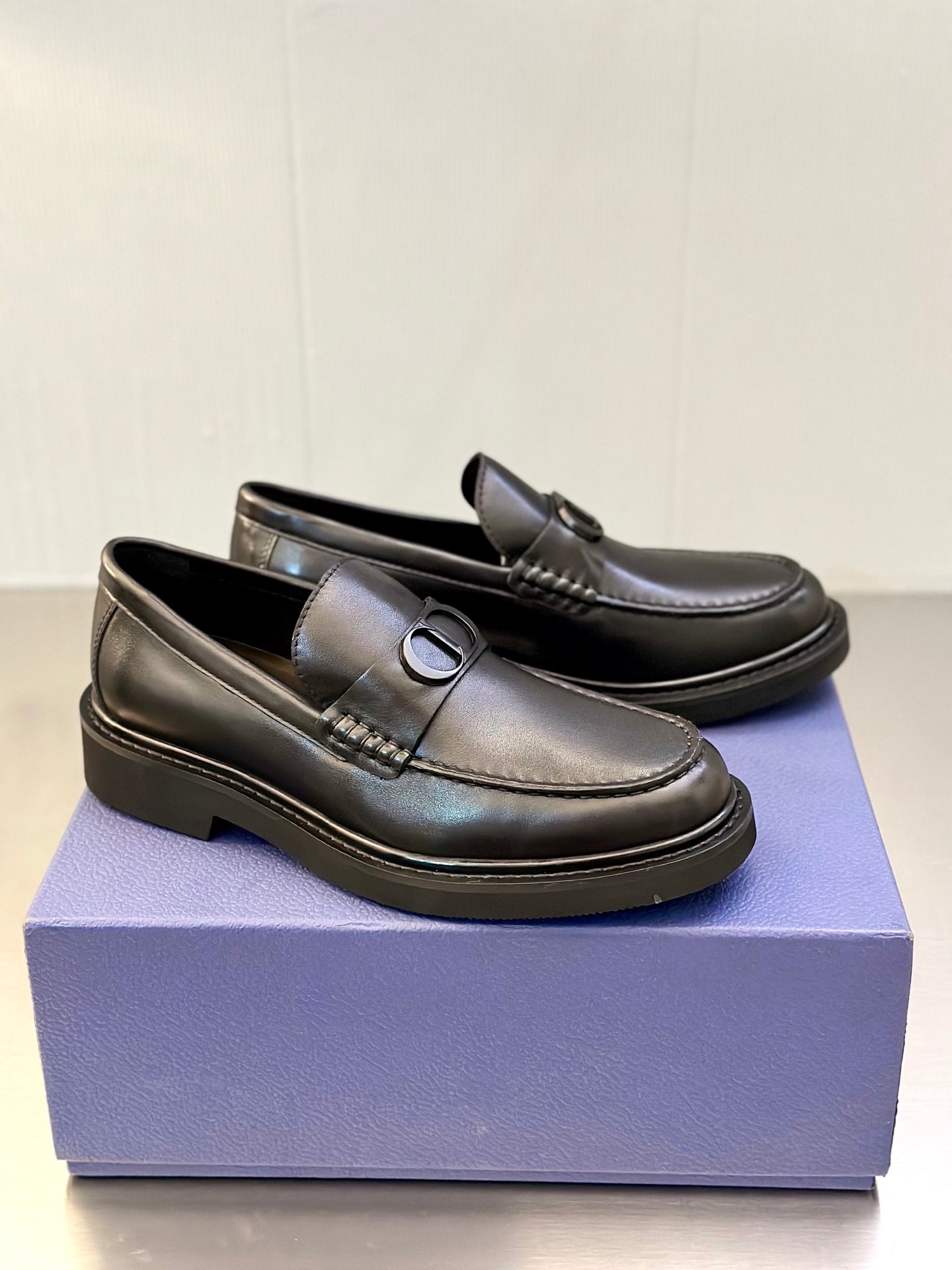 Dark leather Dior loafers with D buckle and stitched side detail, low platform sole