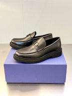 Dark leather slip-on loafers with gold-tone D buckle and low platform sole