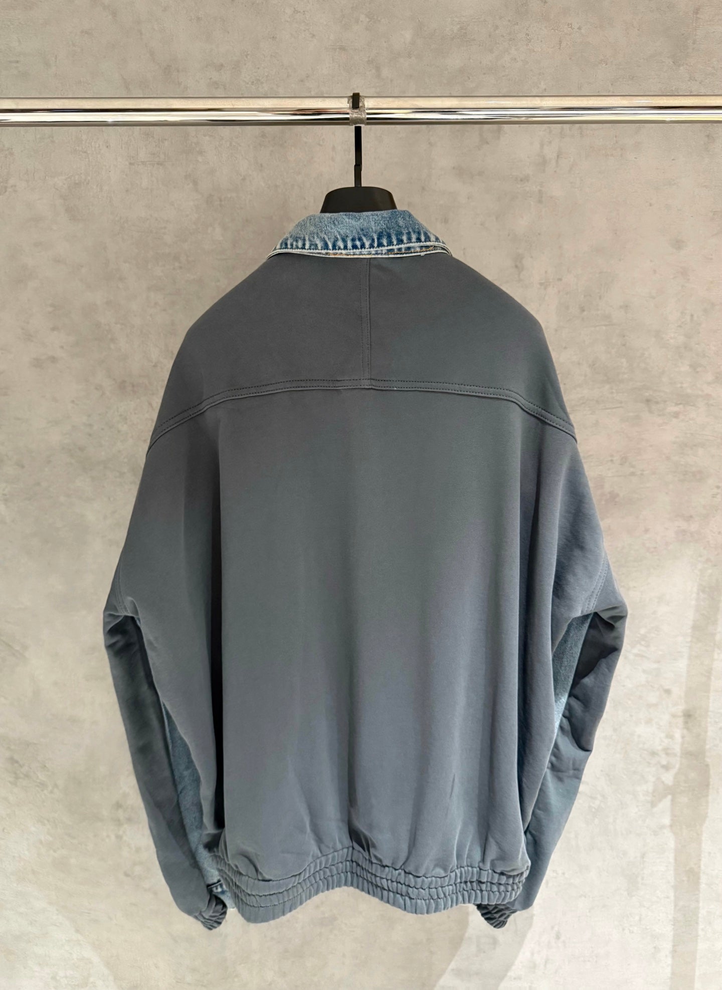 Charcoal denim jacket back view with ribbed hem and button placket