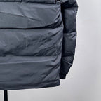 Dark gray long puffer jacket, padded front panel close-up with stitching details