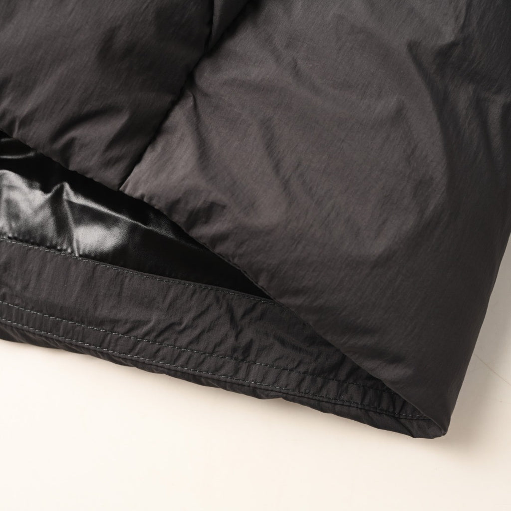 Long puffer jacket lower hem with elastic trim and stitched seam